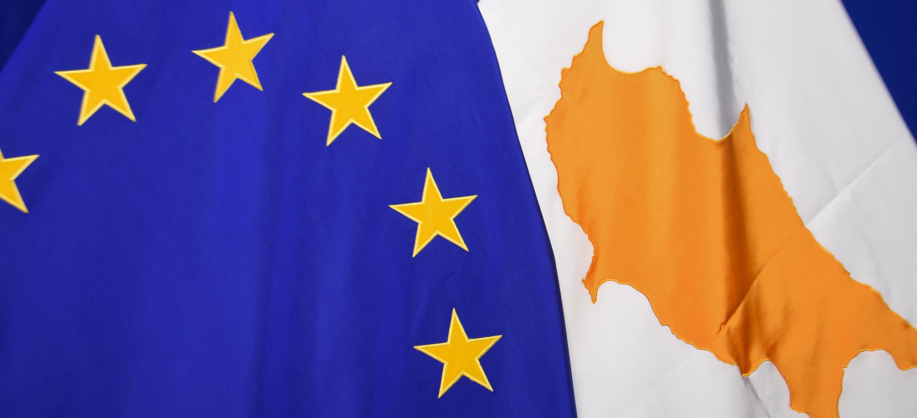 The national flag of Cyprus next to the European flag
