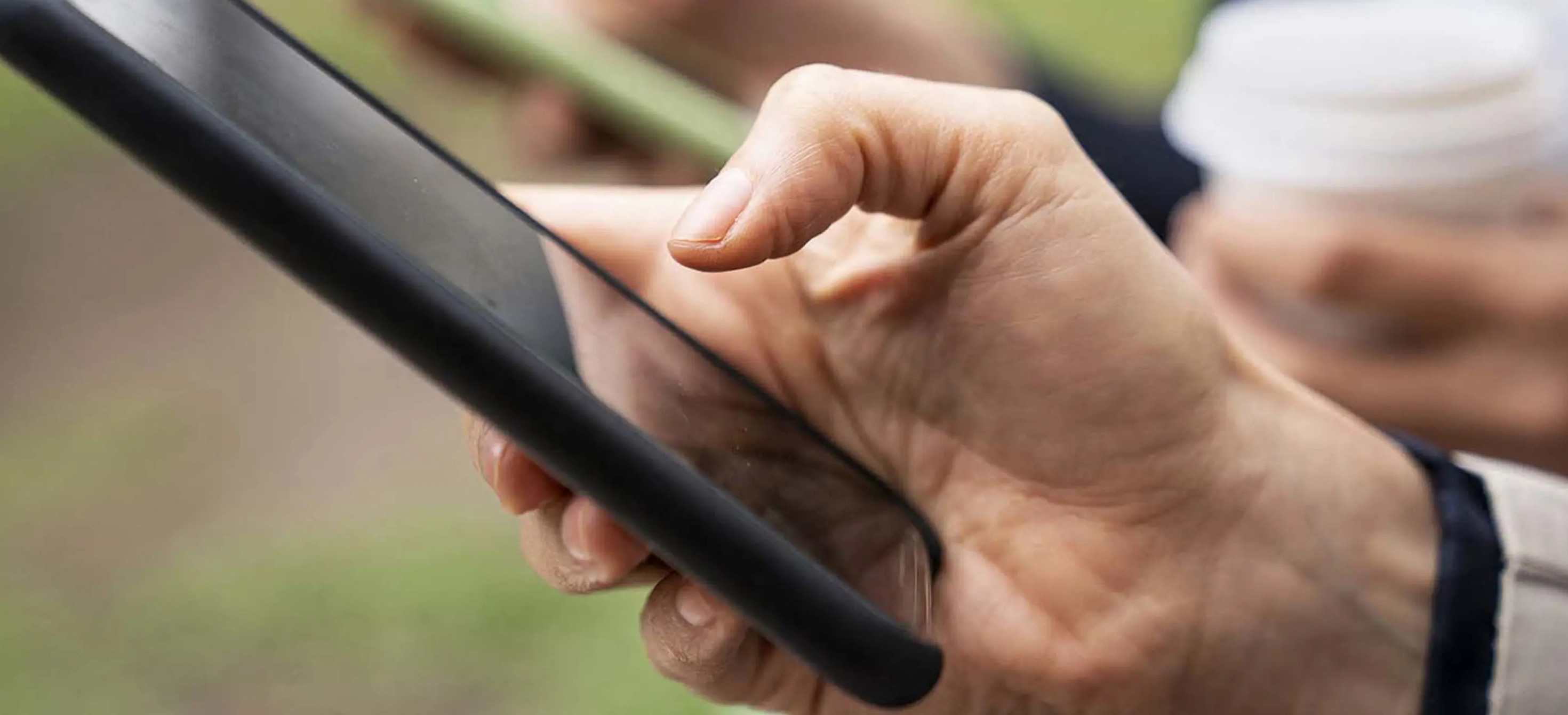 Close-up photo of hands holding smartphones