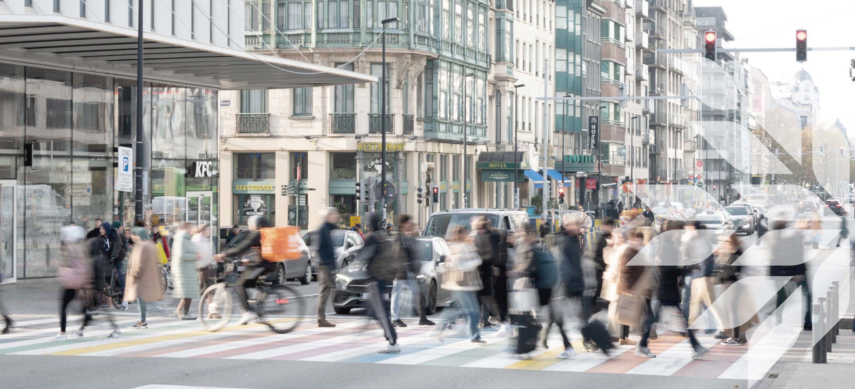 View of a busy market street with people crossing the road