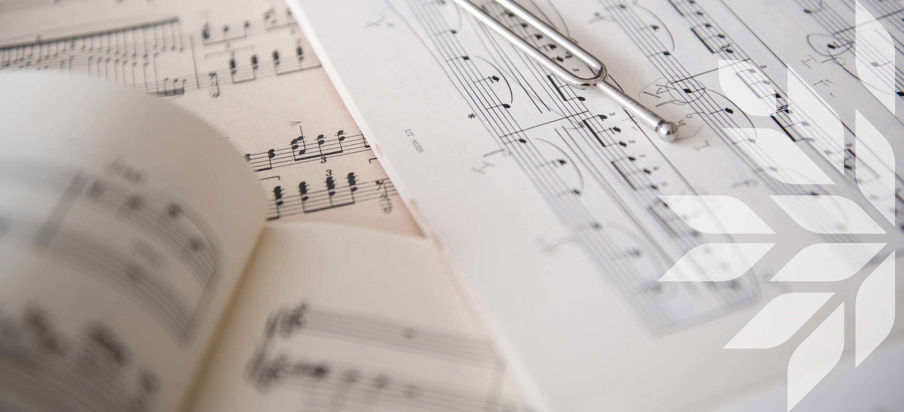 A tuning fork placed on sheet music