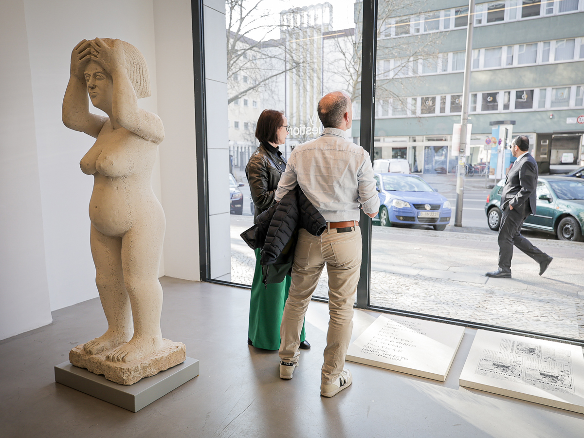 A woman and a man standing next to an exhibit
