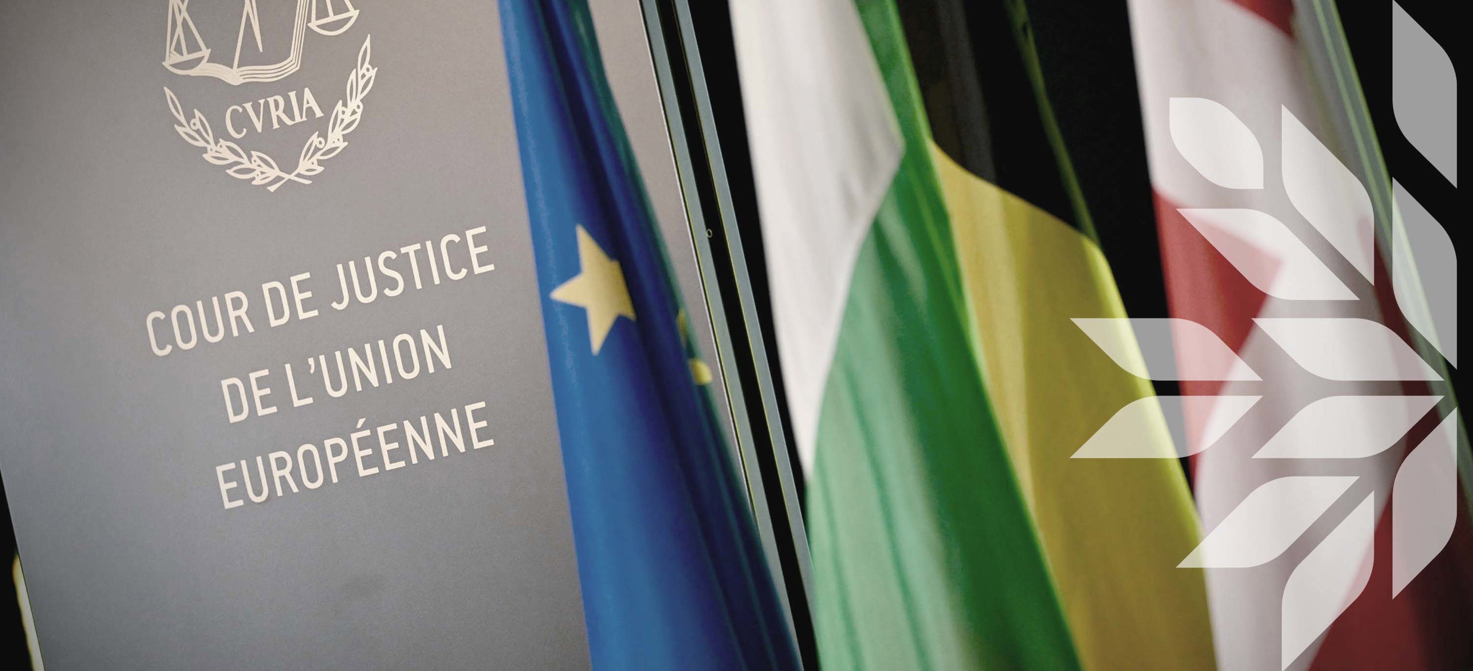 Sign of the Court of Justice of the EU next to European and National flags