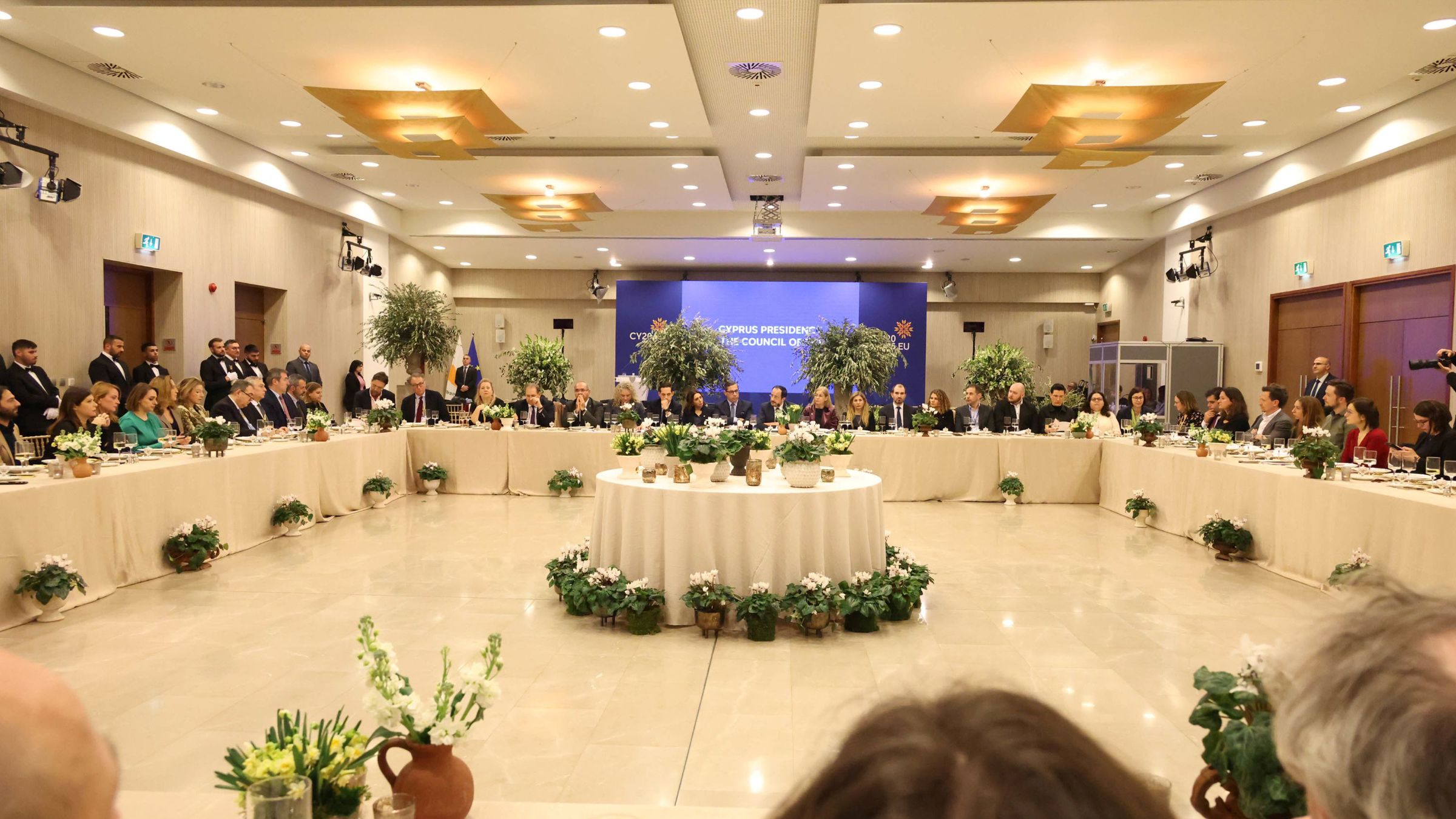 people sitting around square table