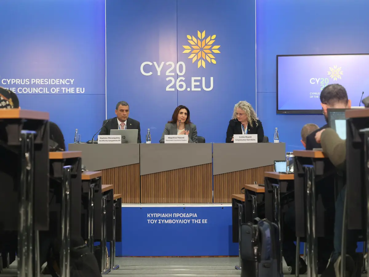 three people sitting on podium